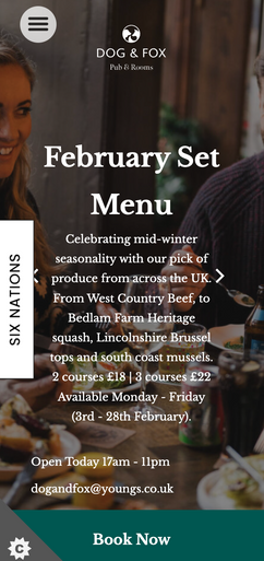 A February menu advertises a set menu featuring seasonal UK produce, including beef and mussels. It's displayed digitally, likely on a restaurant's website or app, and shows a blurred image of people dining. 2 courses £18 | 3 courses £22. Available Monday - Friday (3rd - 28th February). Open Today 17am - 11pm dogandfox@youngs.co.uk