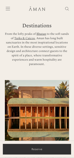 A low, colonnaded building reflects in a still body of water; it is located amidst palm trees. The text reads: AMAN Destinations From the lofty peaks of Bhutan to the soft sands of Turks & Caicos, Aman has long built sanctuaries in the most inspirational locations on Earth. In these diverse settings, sensitive design and architecture connect guests to the spirit of a place, where transformative experiences and warm hospitality are paramount. Reserve